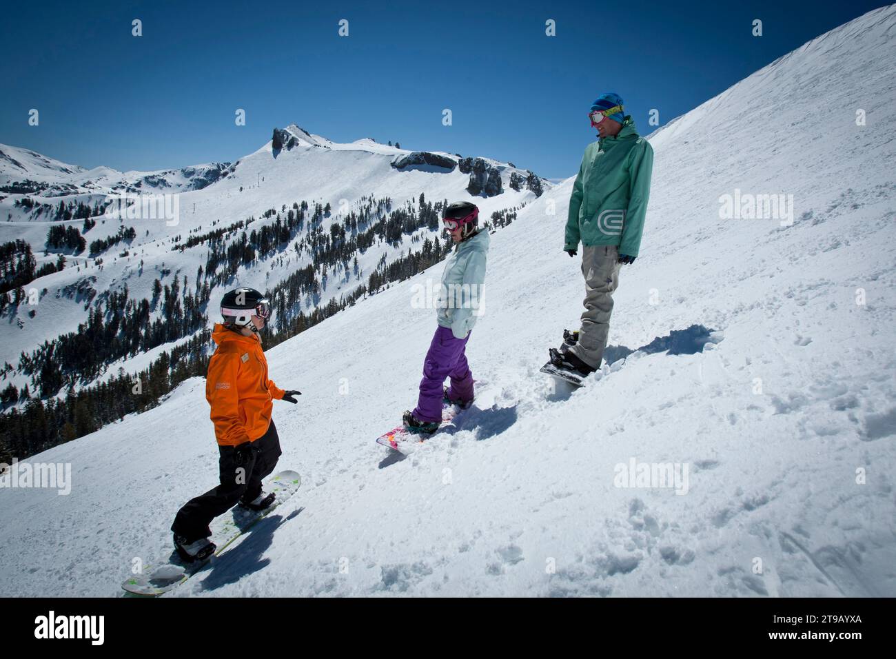 Snowboard instructor giving a lesson at a ski resort. Stock Photo