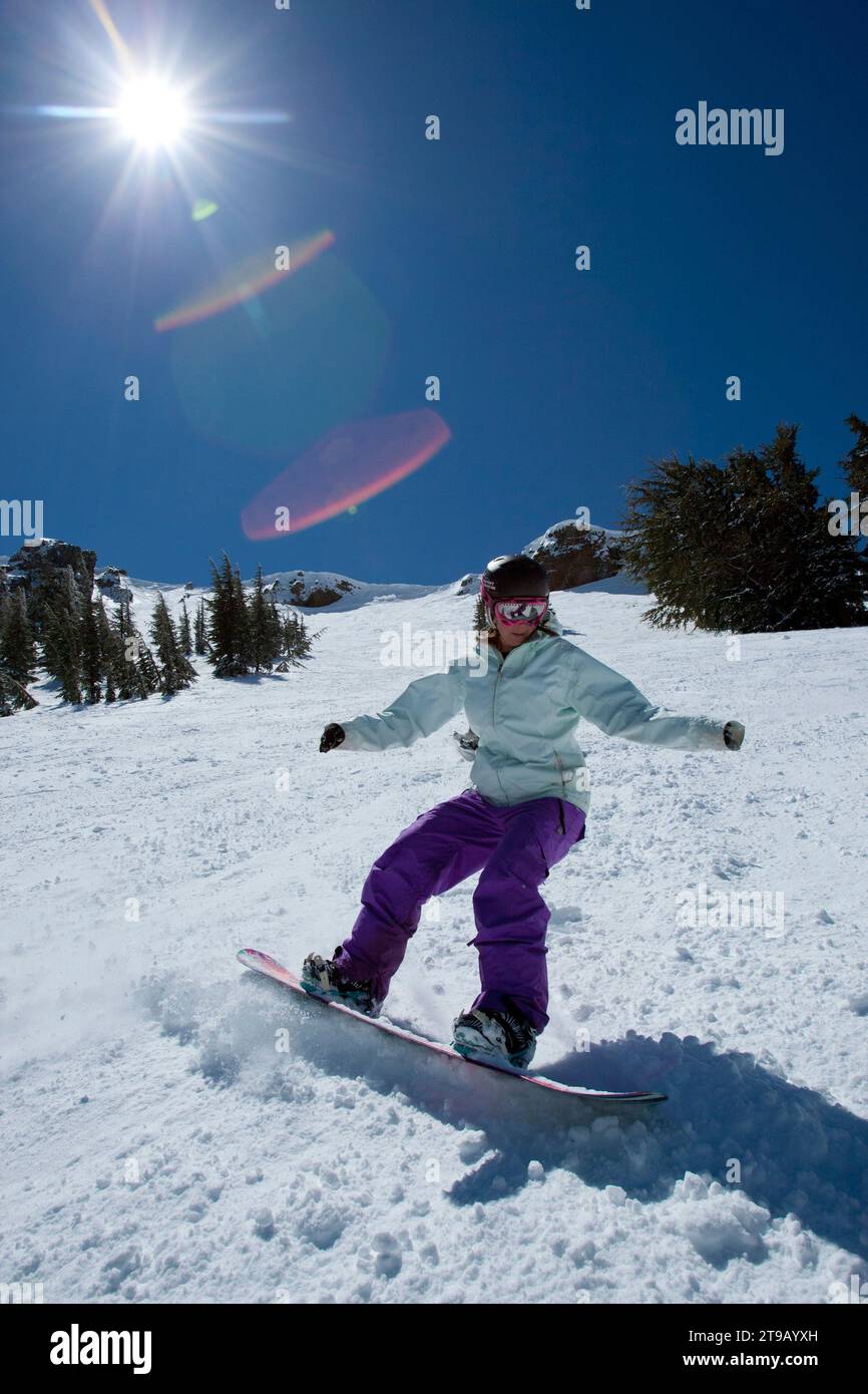 Snowboarder riding spring conditions. Stock Photo