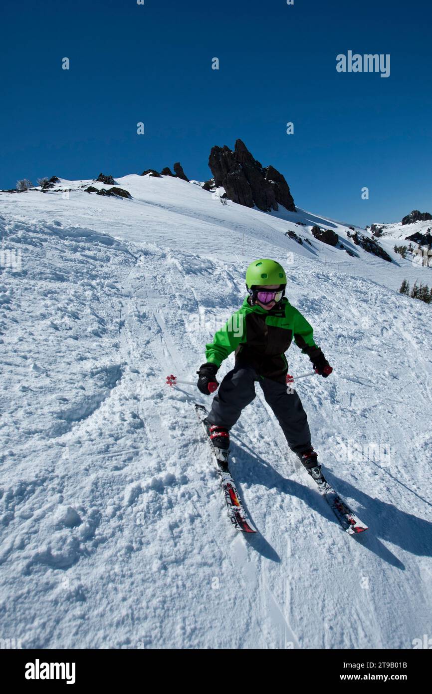One young skier working his way down steep terrain. Stock Photo