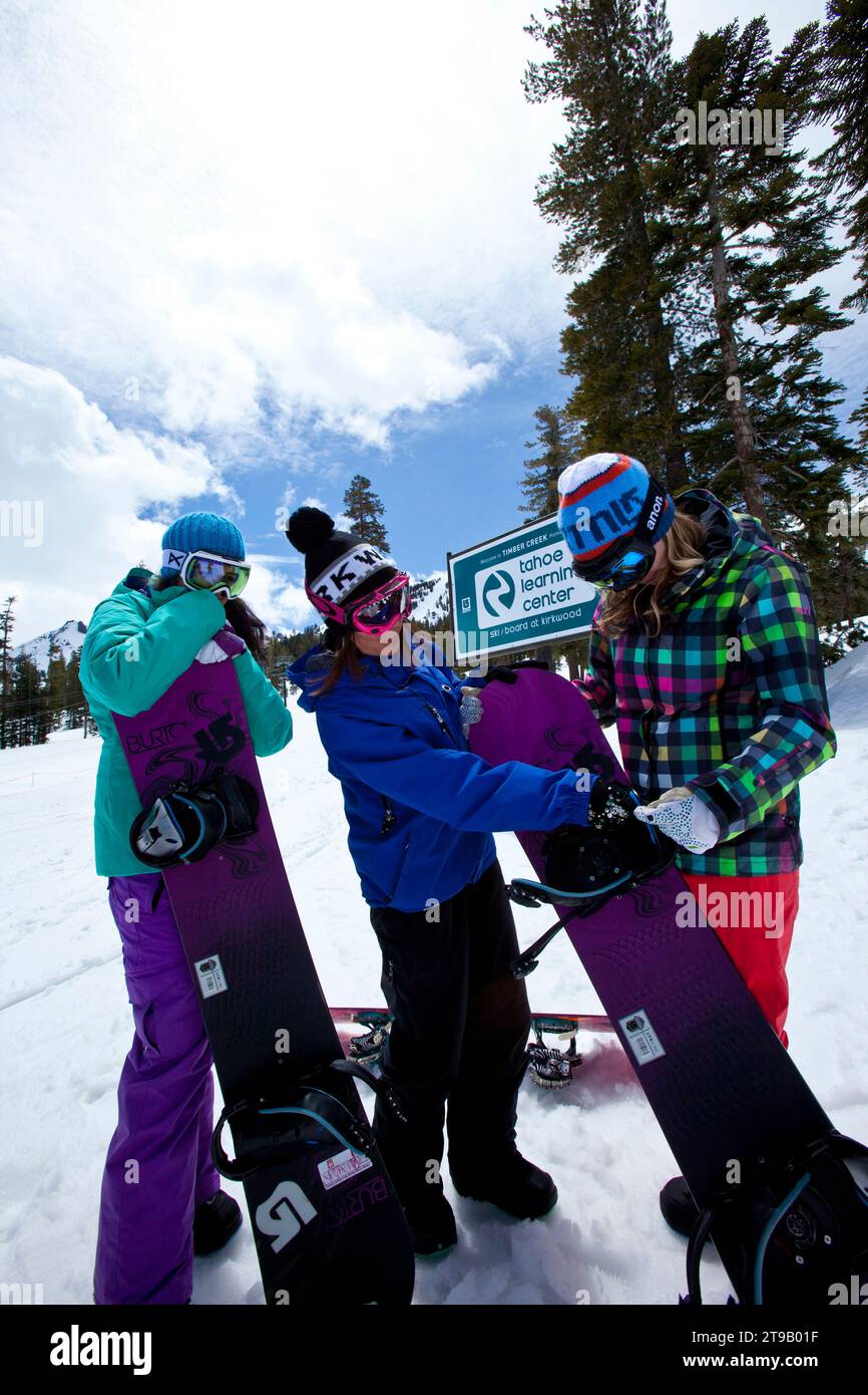 Two snowboard students listening to their snowboard instructor. Stock Photo