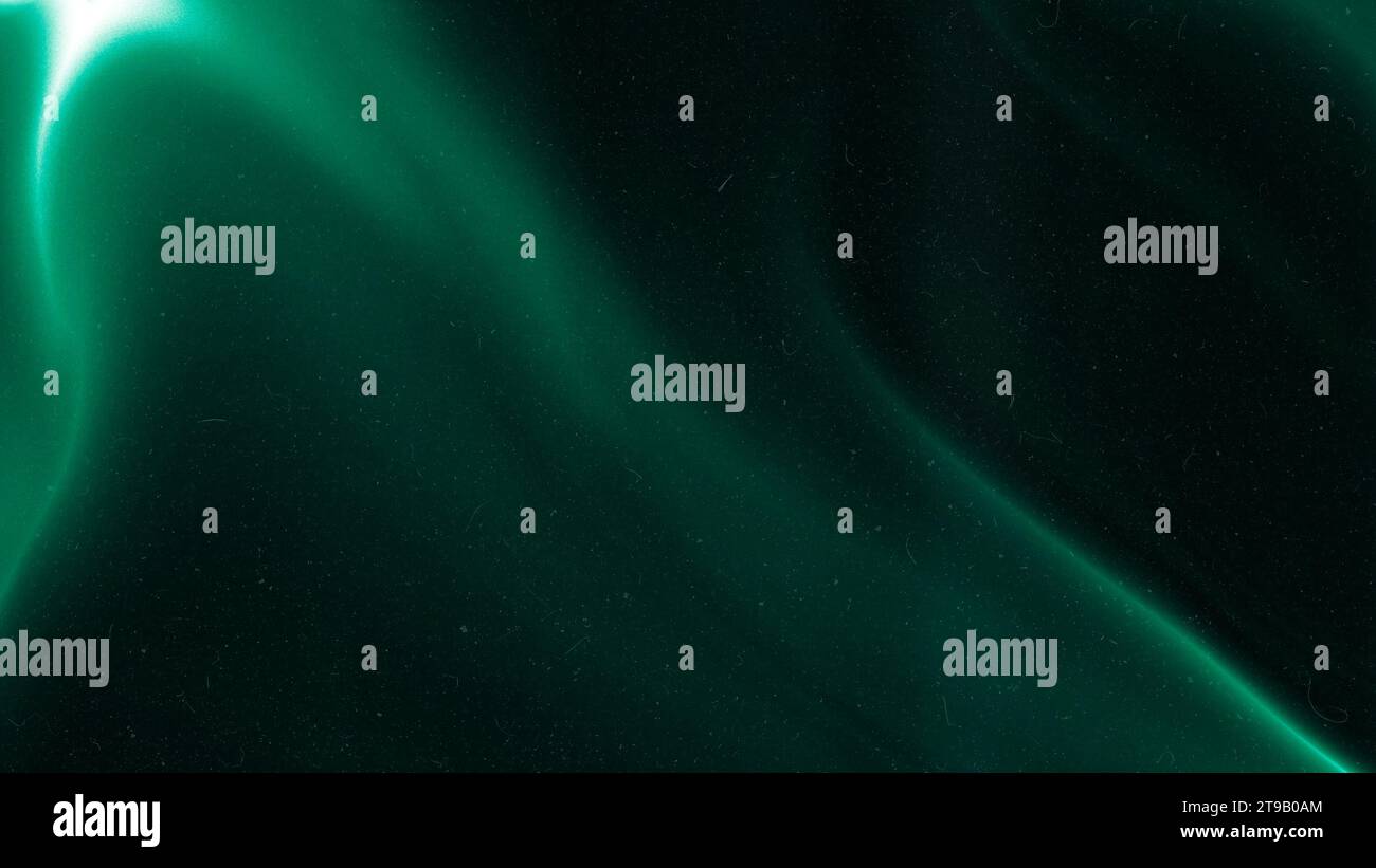 Green emerald color gradient grainy background. Illuminated spots on