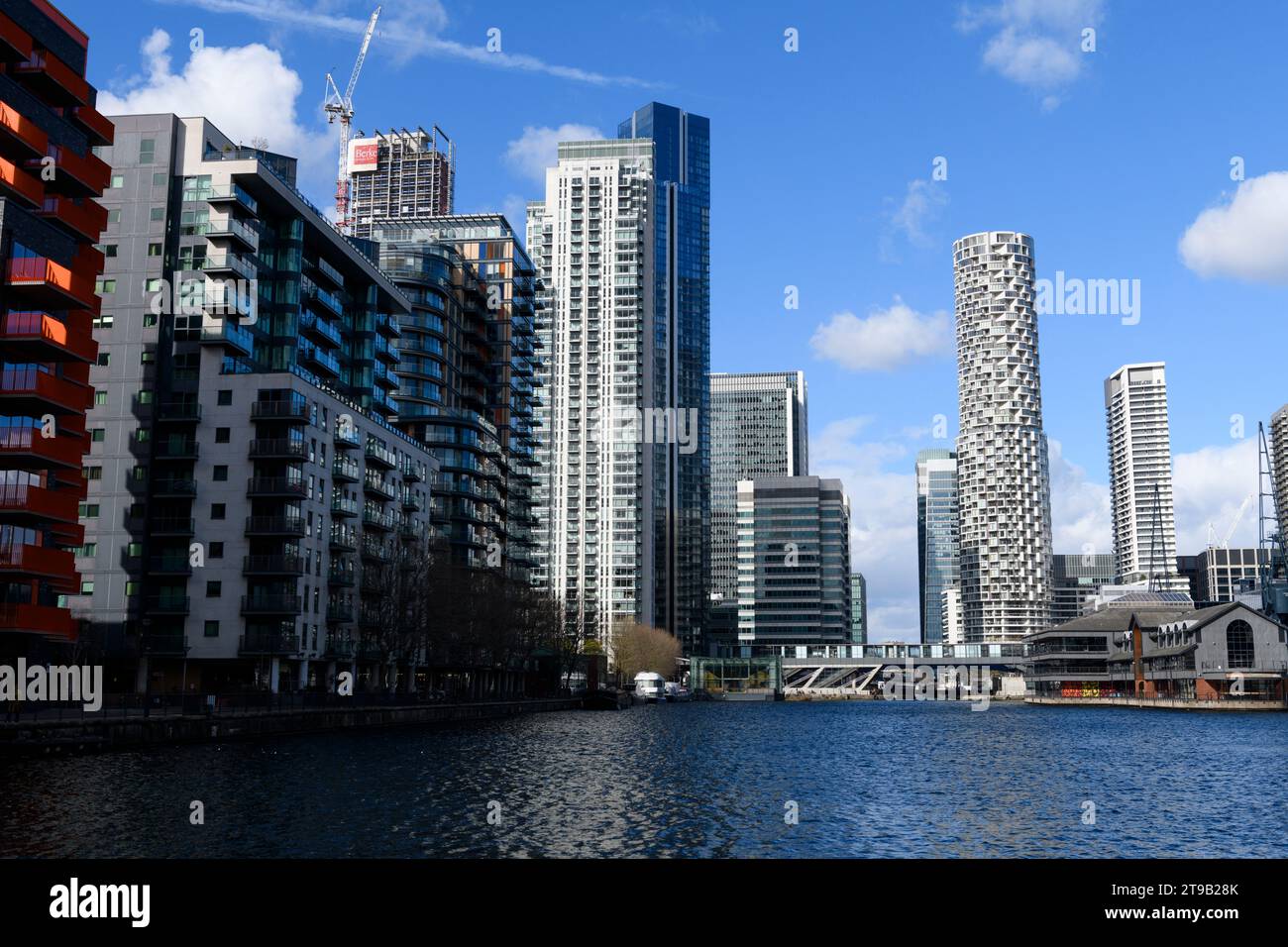 Looking North down Millwall Inner Dock, the white circular skyscraper is One Park Drive a residential skyscraper located in Canary Wharf. Millwall Inn Stock Photo