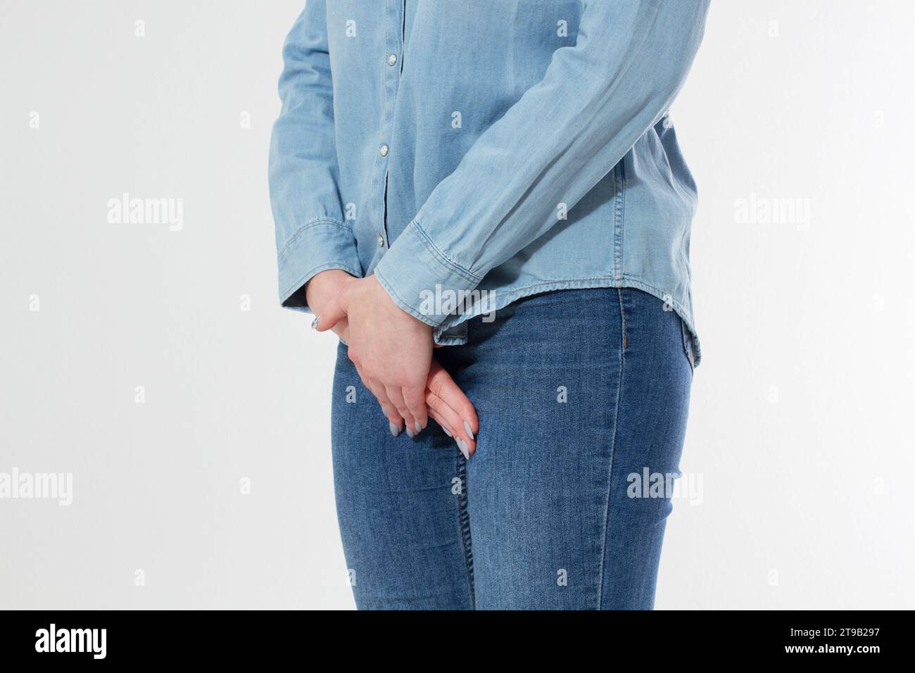 Young beautiful woman having painful stomachache on white background. Chronic gastritis. Abdomen bloating concept. Stock Photo