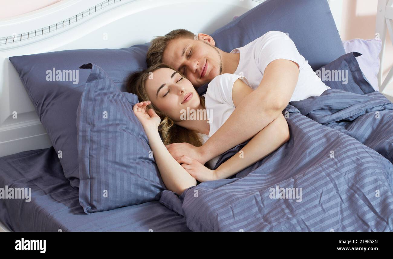 Young cute couple sleeping together in bed in new home Stock Photo - Alamy