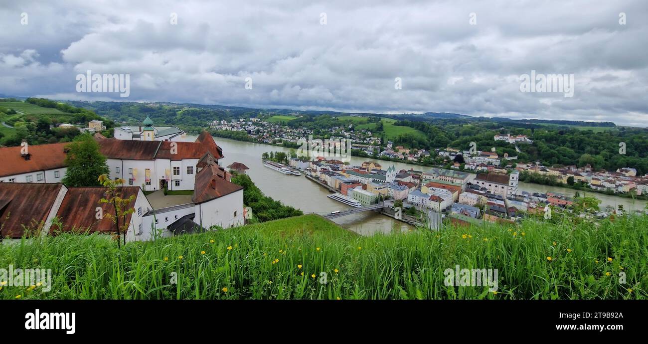 Colorful traditional houses in historical old town Passau, situated on the conjunction of three rivers, Danube, Inn and Iltz. Veste Oberhaus fortress. Stock Photo