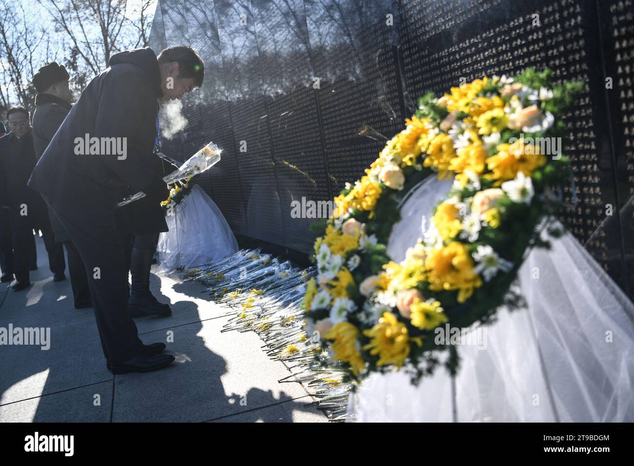 (231124) -- SHENYANG, Nov. 24, 2023 (Xinhua) -- People line up to present flowers to the memorial wall of Chinese People's Volunteers (CPV) martyrs at the CPV martyrs' cemetery in Shenyang, northeast China's Liaoning Province, Nov. 24, 2023. The remains of 25 CPV soldiers killed in the War to Resist U.S. Aggression and Aid Korea (1950-1953) were buried Friday in a cemetery in Shenyang.The remains of the fallen soldiers were returned to China from the Republic of Korea on Thursday. It was the 10th such repatriation since 2014, following a handover agreement signed between the two countries. Thi Stock Photo