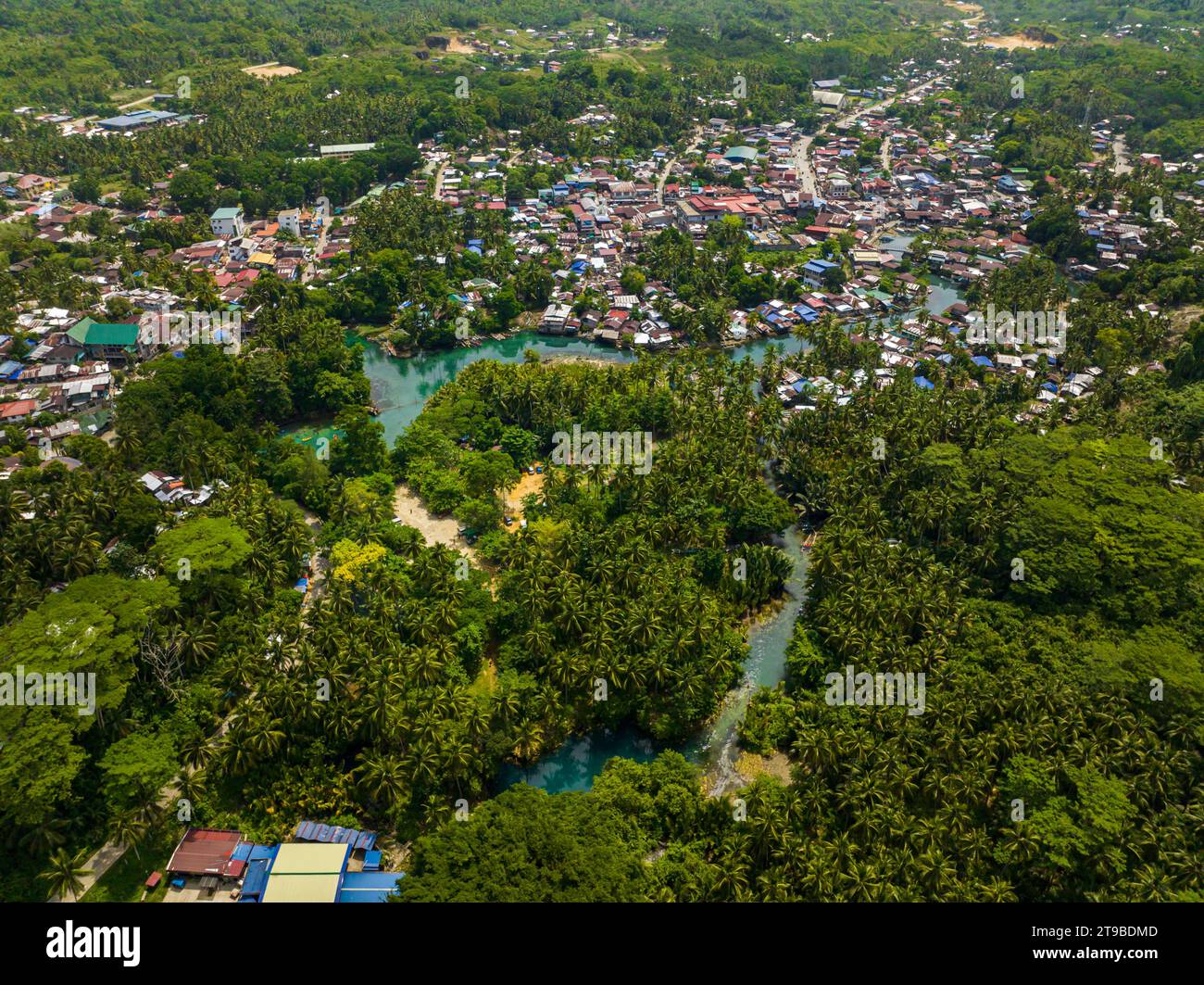 Barobo town with houses and buildings. River surrounded bt green plants and trees in Surigao del Sur. Philippines. Stock Photo