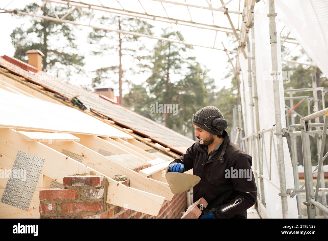 Bricklayer working on construction site Stock Photo