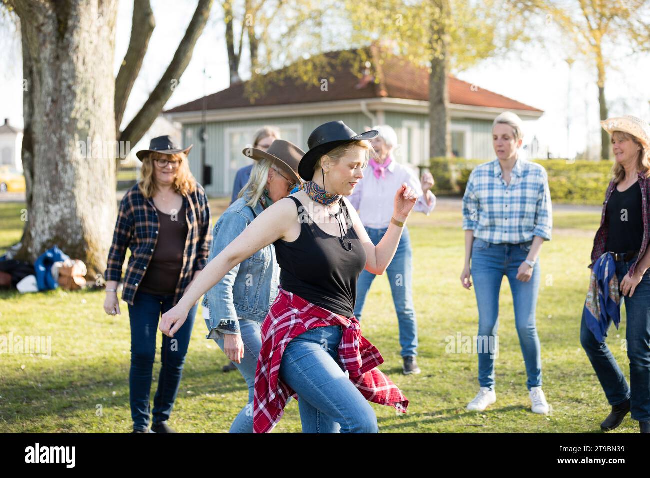 Woman dancing together in park Stock Photo
