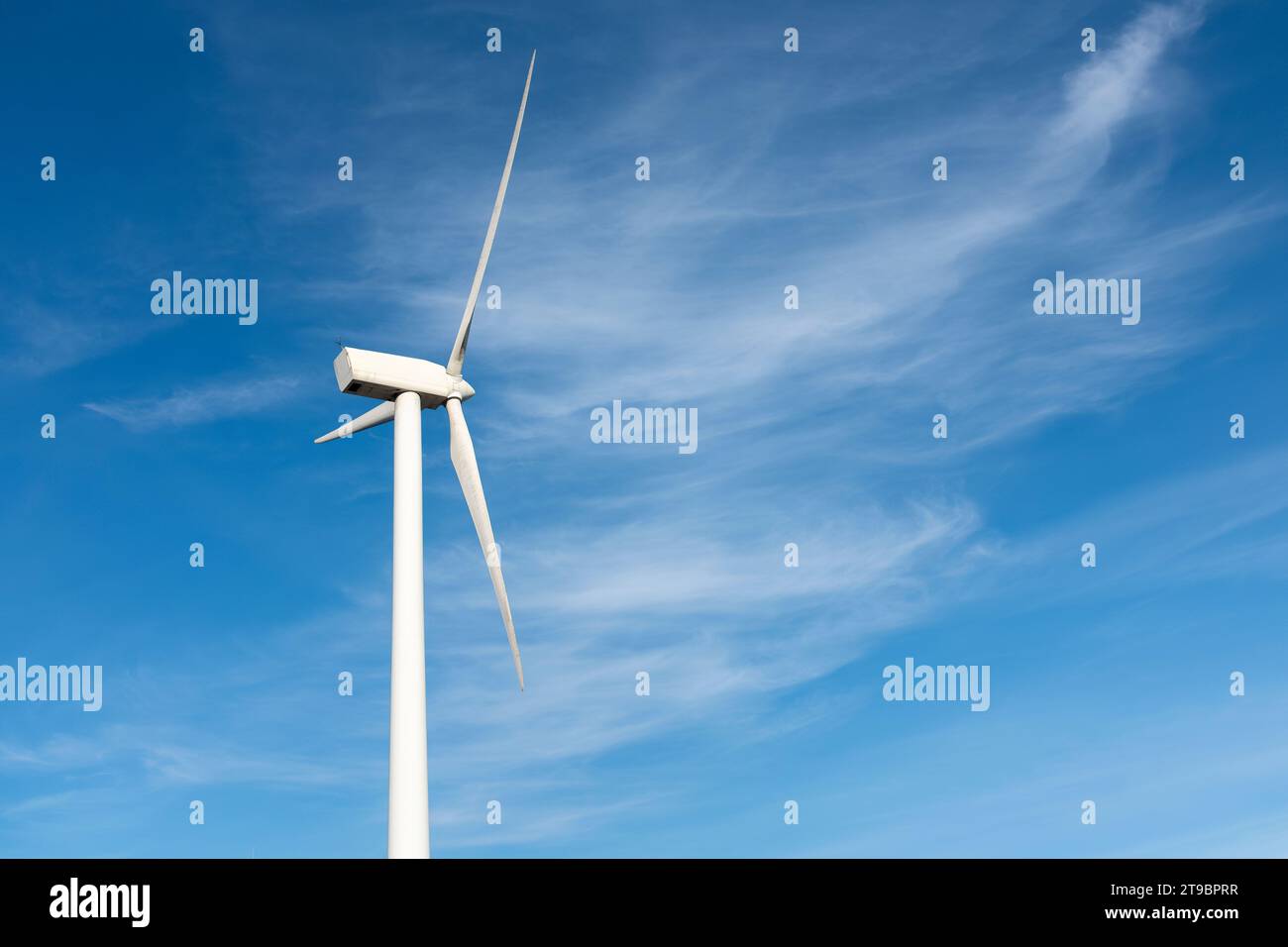Wind turbine against blue sky Stock Photo - Alamy