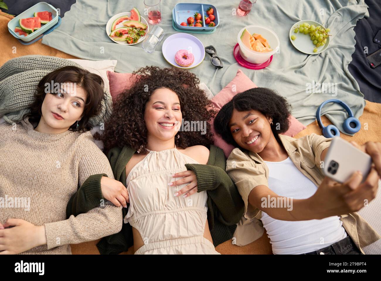 Happy teenage girls taking selfie at picnic Stock Photo
