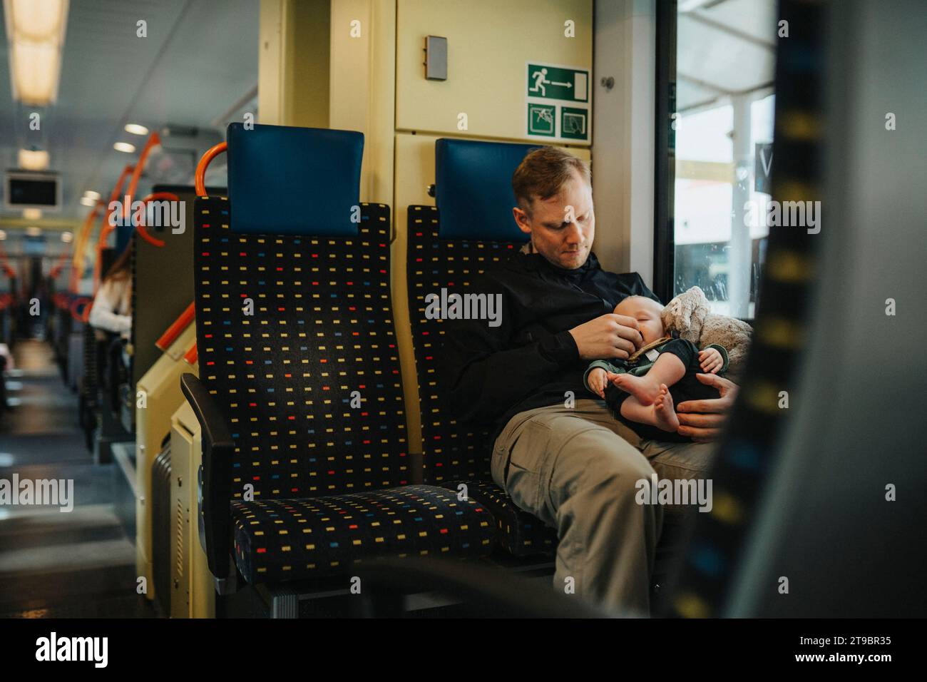 Father traveling with baby by train Stock Photo