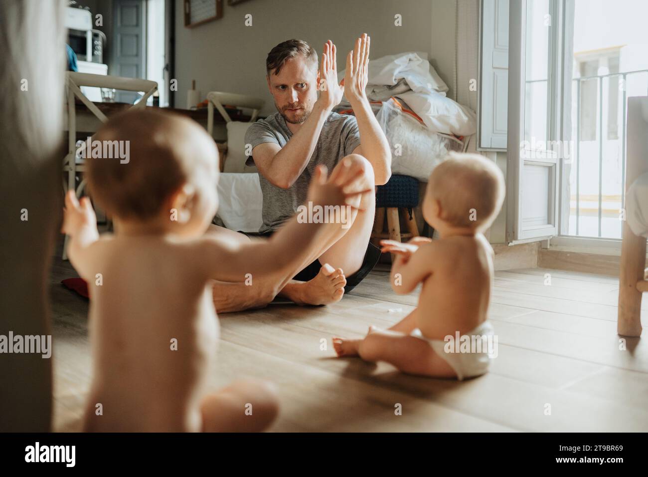 Father taking care of babies at home Stock Photo