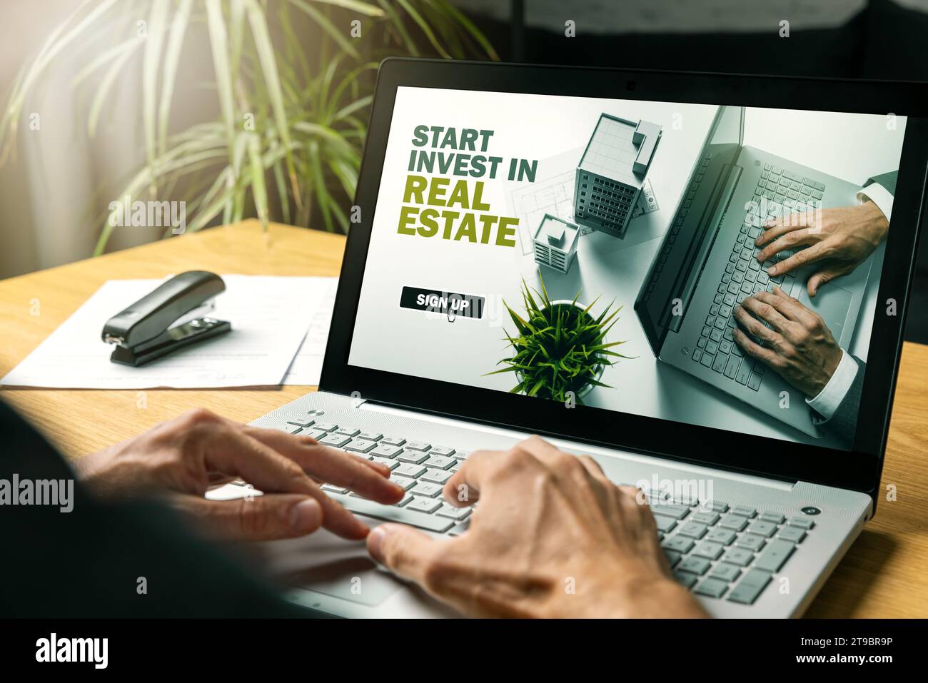 man using laptop to start invest in online real estate crowdfunding platform Stock Photo