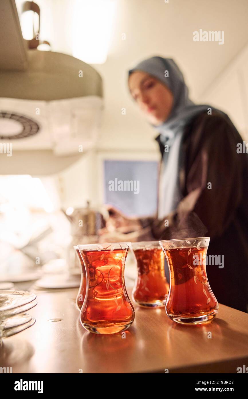 Woman preparing evening tea at home Stock Photo