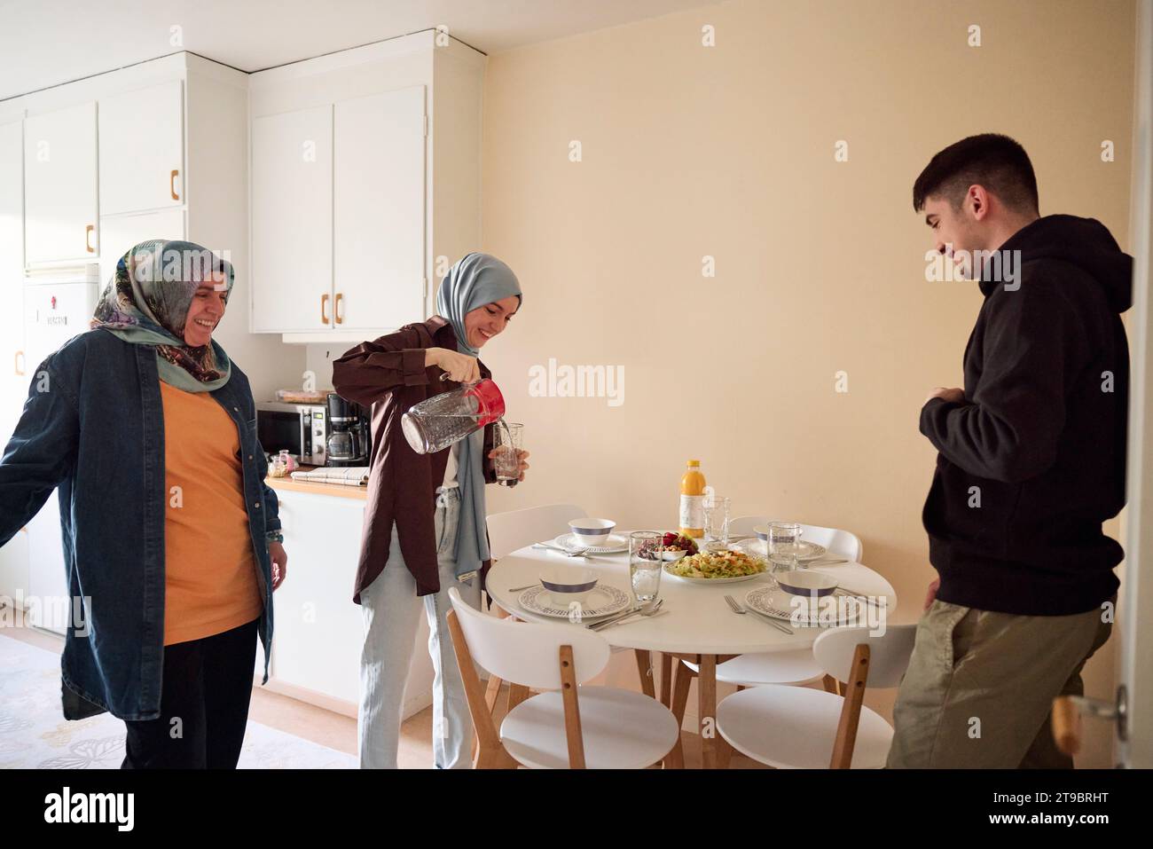 Family setting table for eid al-fitr together at home Stock Photo