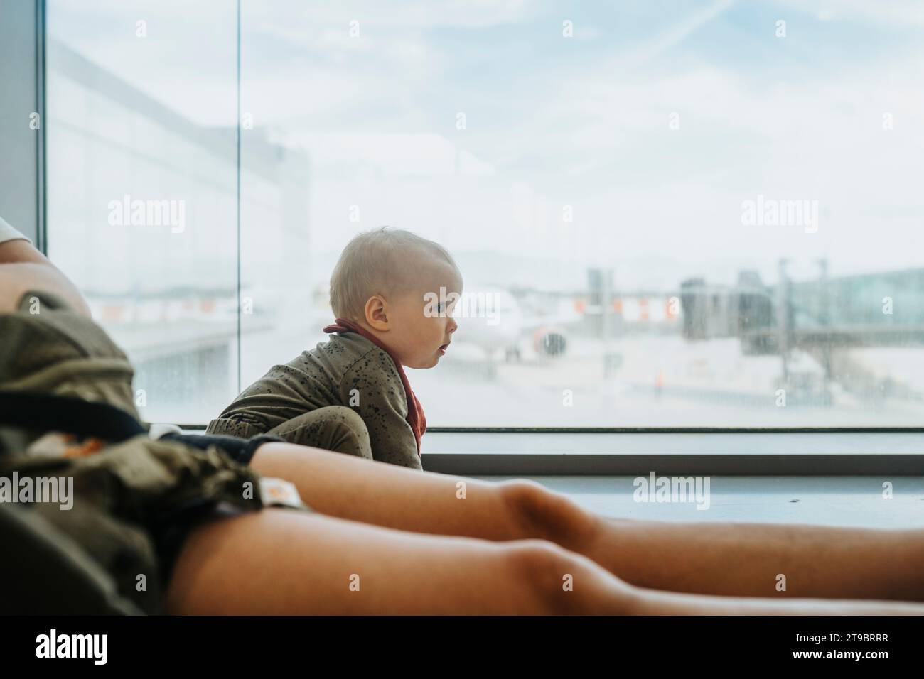 Mother with baby waiting at airport Stock Photo