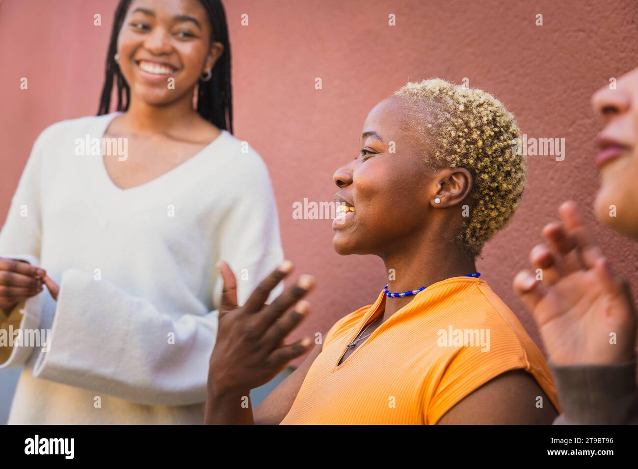 Cheerful young female friends talking while enjoying weekend Stock Photo