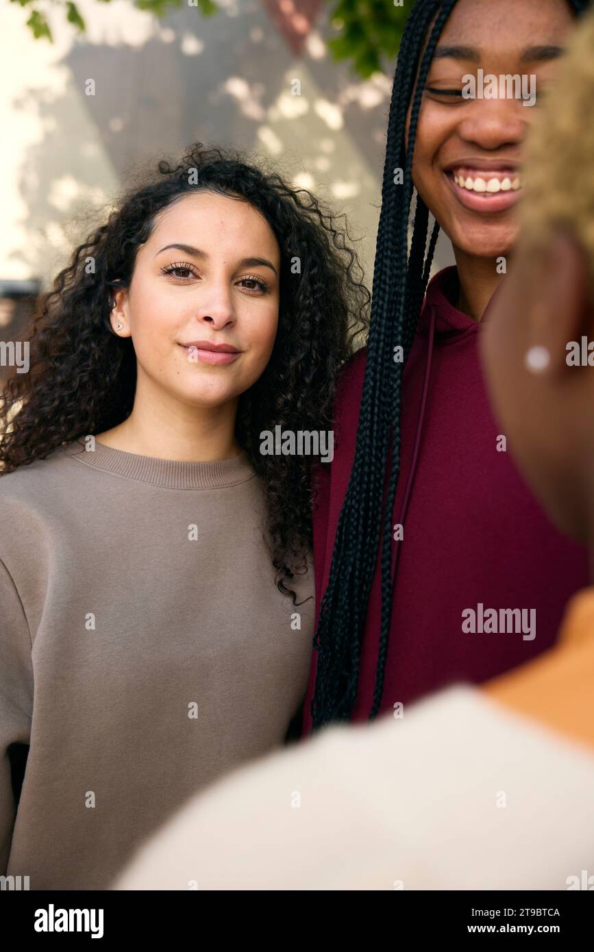 Portrait of young woman with smiling female friends Stock Photo