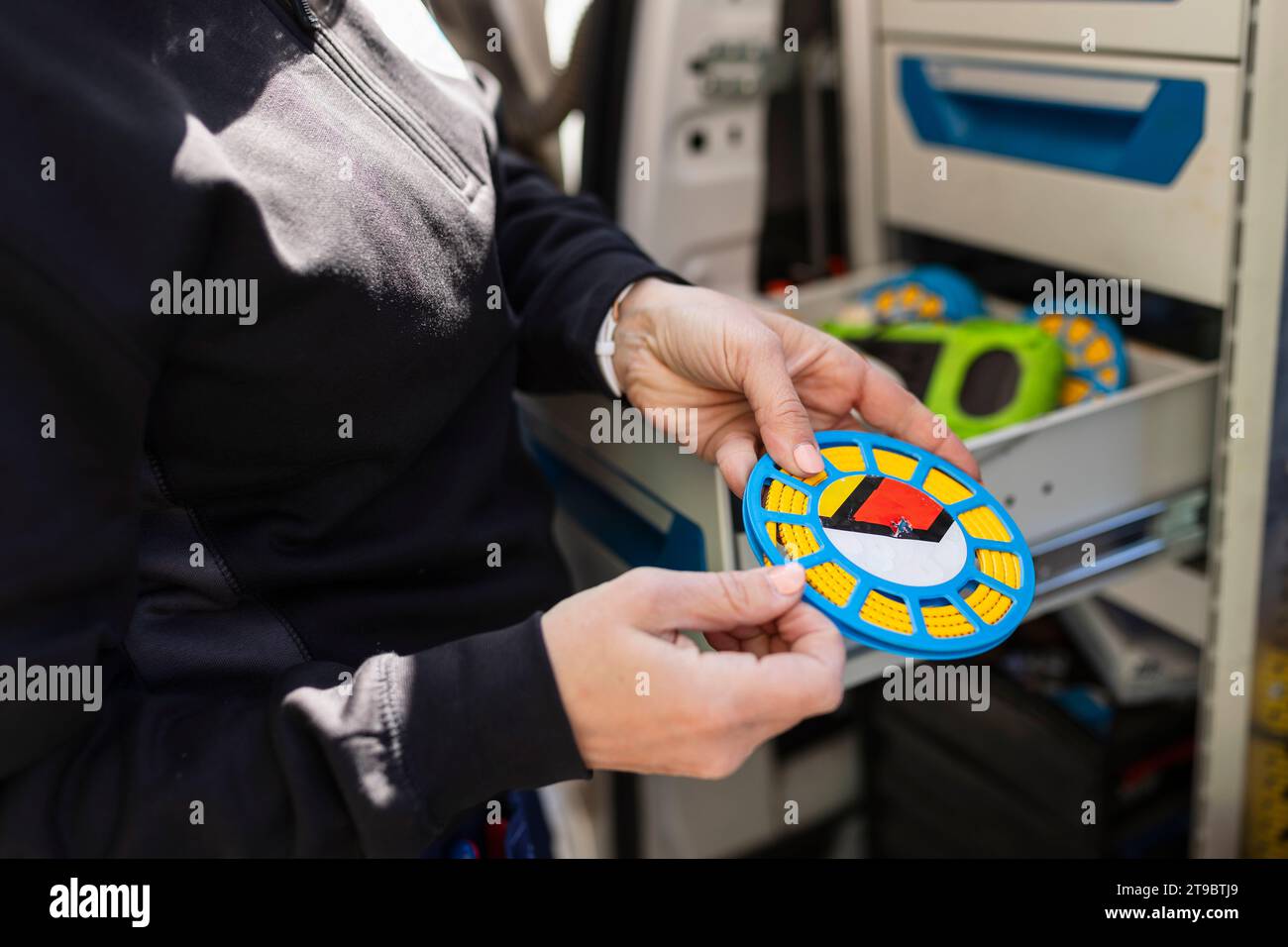Midsection of female electrician with cable marker Stock Photo