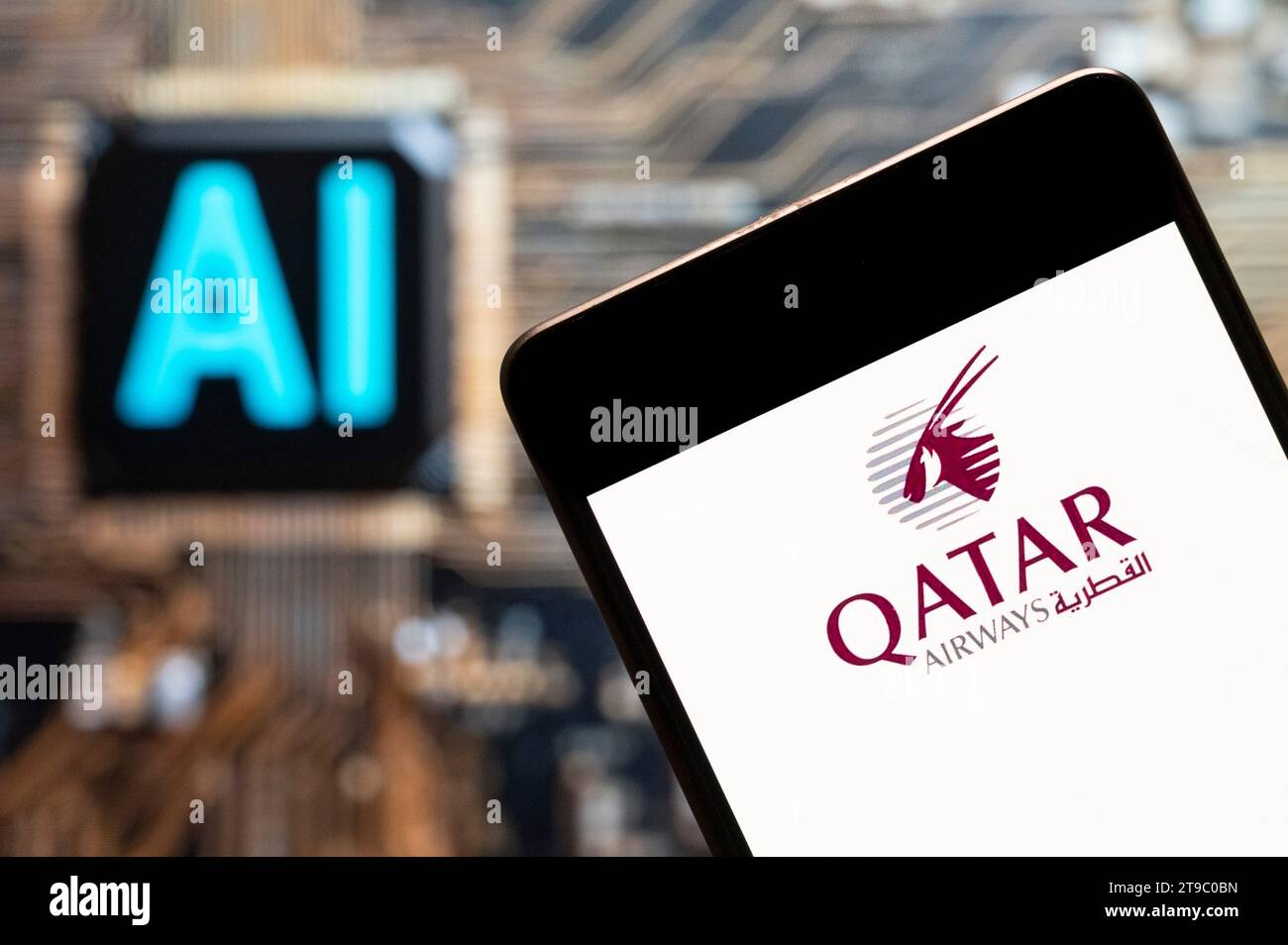 In this photo illustration, the state-owned flag carrier airline of Qatar, Qatar Airways logo seen displayed on a smartphone with an Artificial intelligence (AI) chip and symbol in the background. (Photo by Budrul Chukrut / SOPA Images/Sipa USA) *** Strictly for editorial news purposes only *** Stock Photo