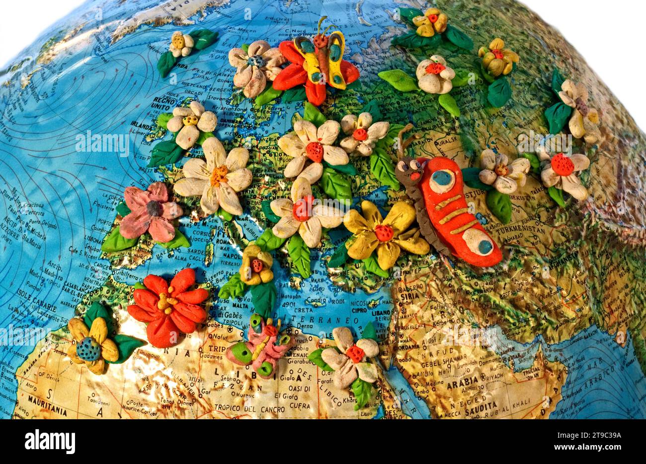 World Globe centered on Europe covered by flowers, Mixed technique: objects and clay Stock Photo