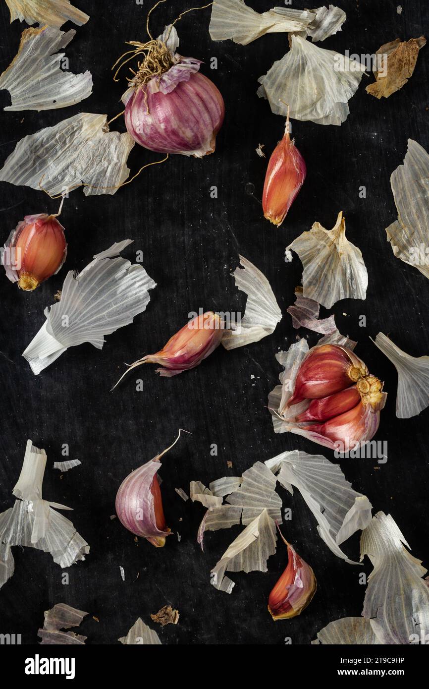 Fresh garlic bulbs and cloves grouped on black background. Flat lay ...