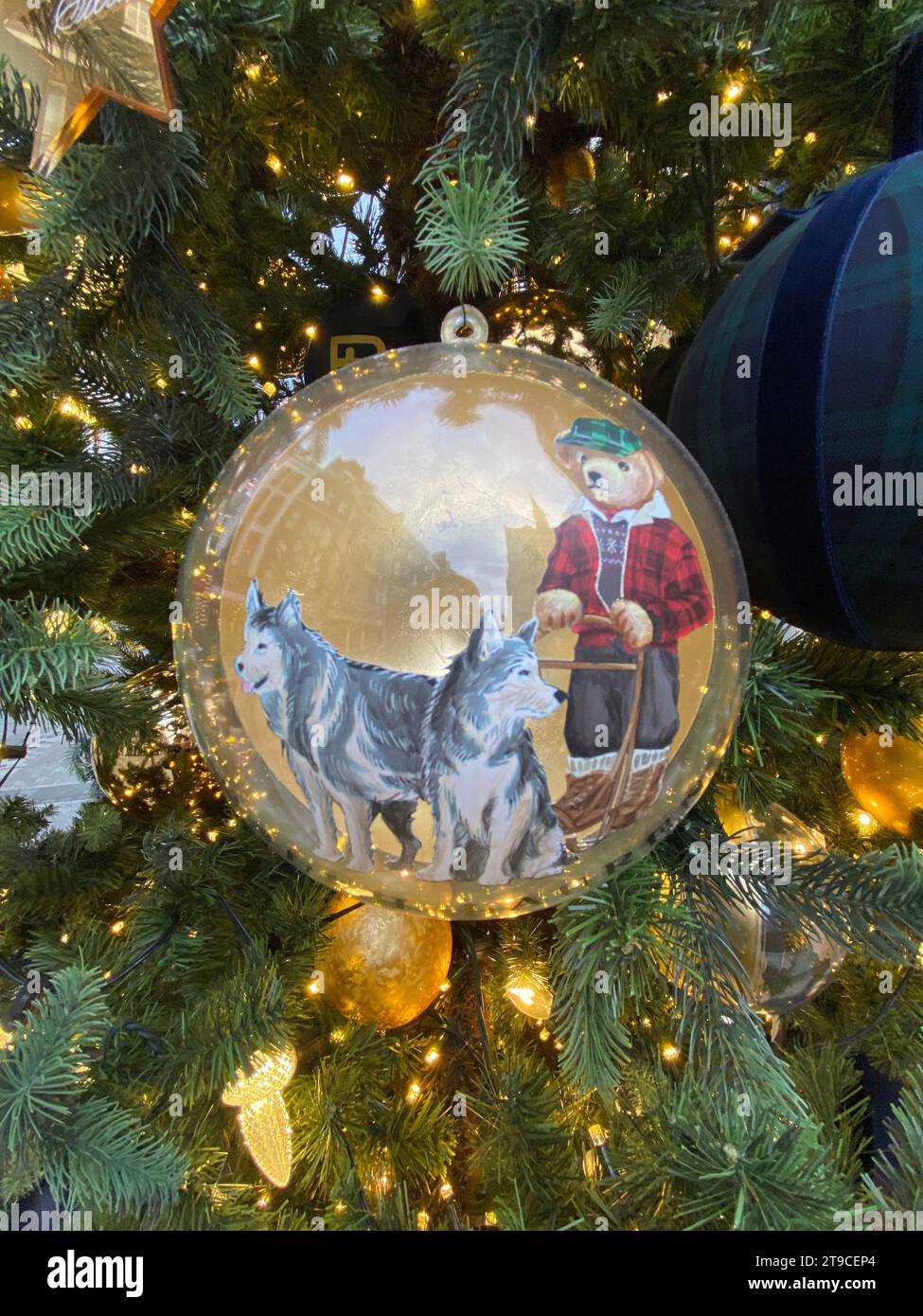 Outside the brand's flagship store stands a five meter Nordmann Fir tree decorated with hand painted bear baubles .Visitors are welcome to donate to The Royal Marsden Cancer Charity and dedicate a personalised star to be featured on the Ralph Lauren Giving Tree .. Stock Photo