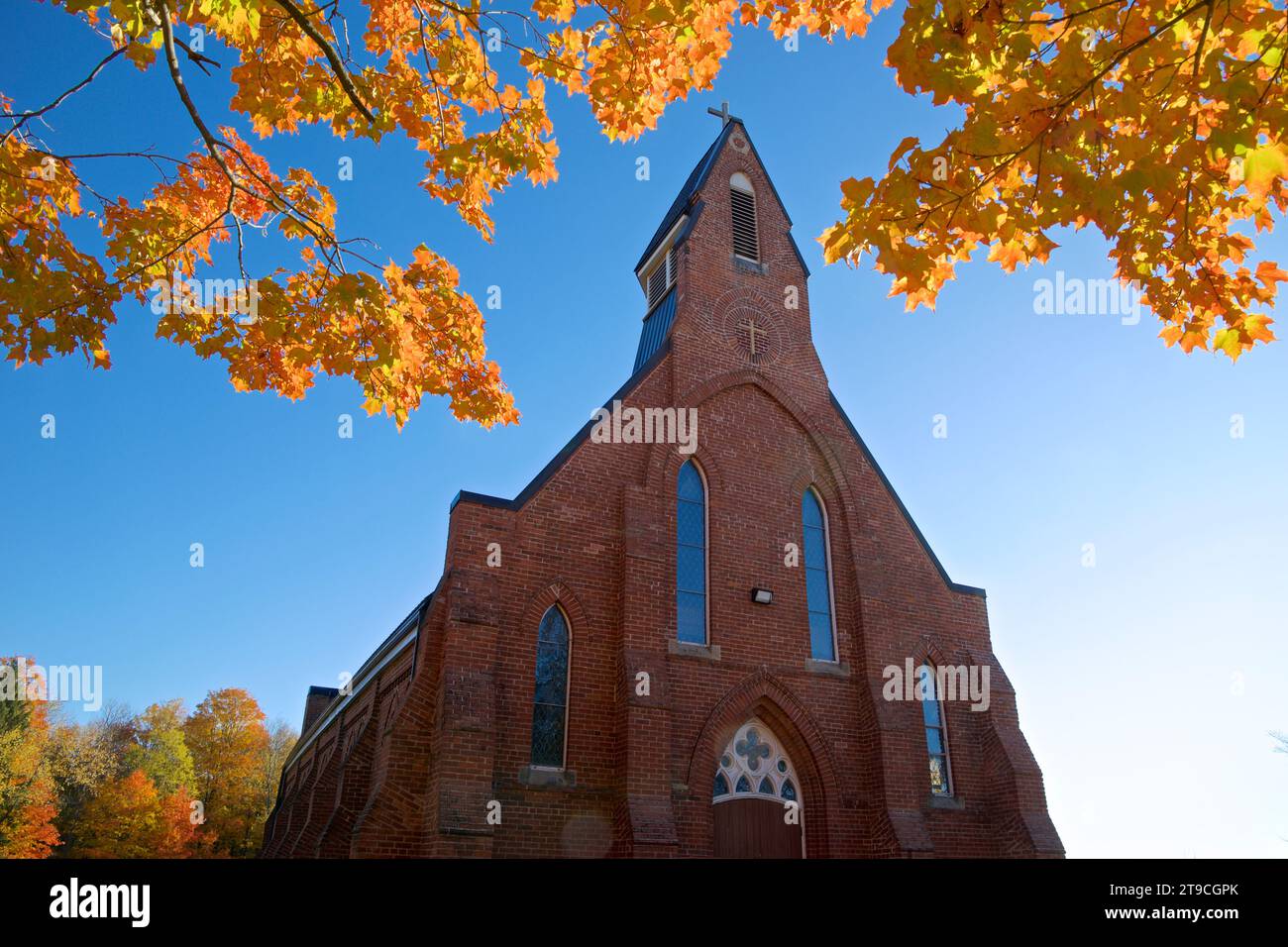 Low angle view of a rural community church with autumn leaf colour Stock Photo