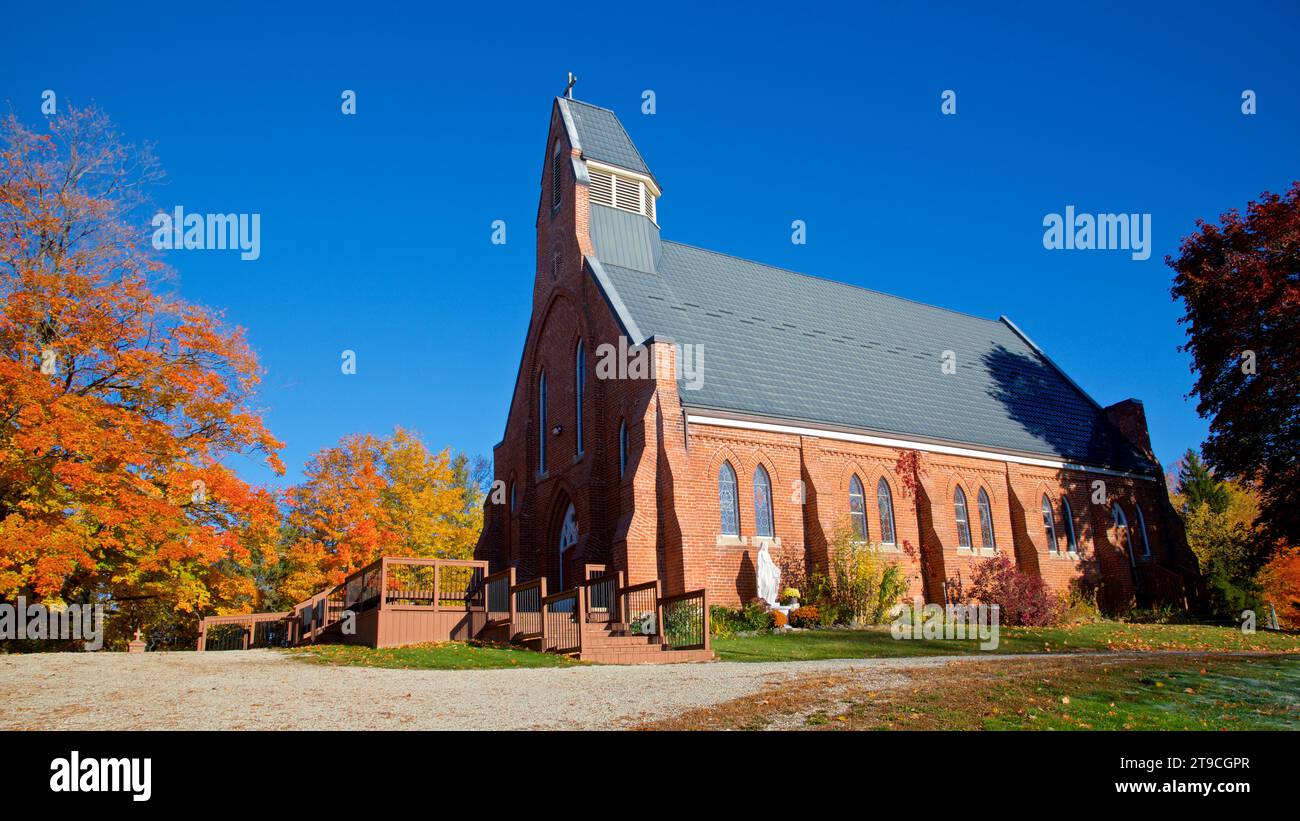 Church in rural community with autumn leaf colour Stock Photo