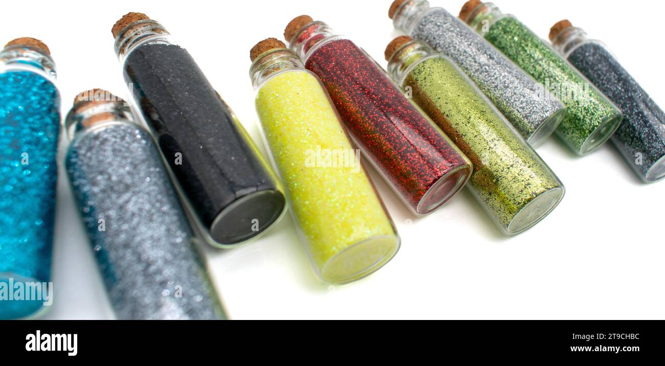 Assortment of glass vials filled with glitter for DIY projects or kids school arts and crafts drawings Stock Photo