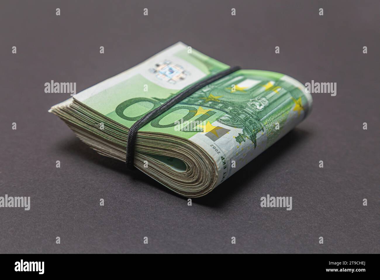 Euro banknotes foldedin half on a black background. Stock Photo