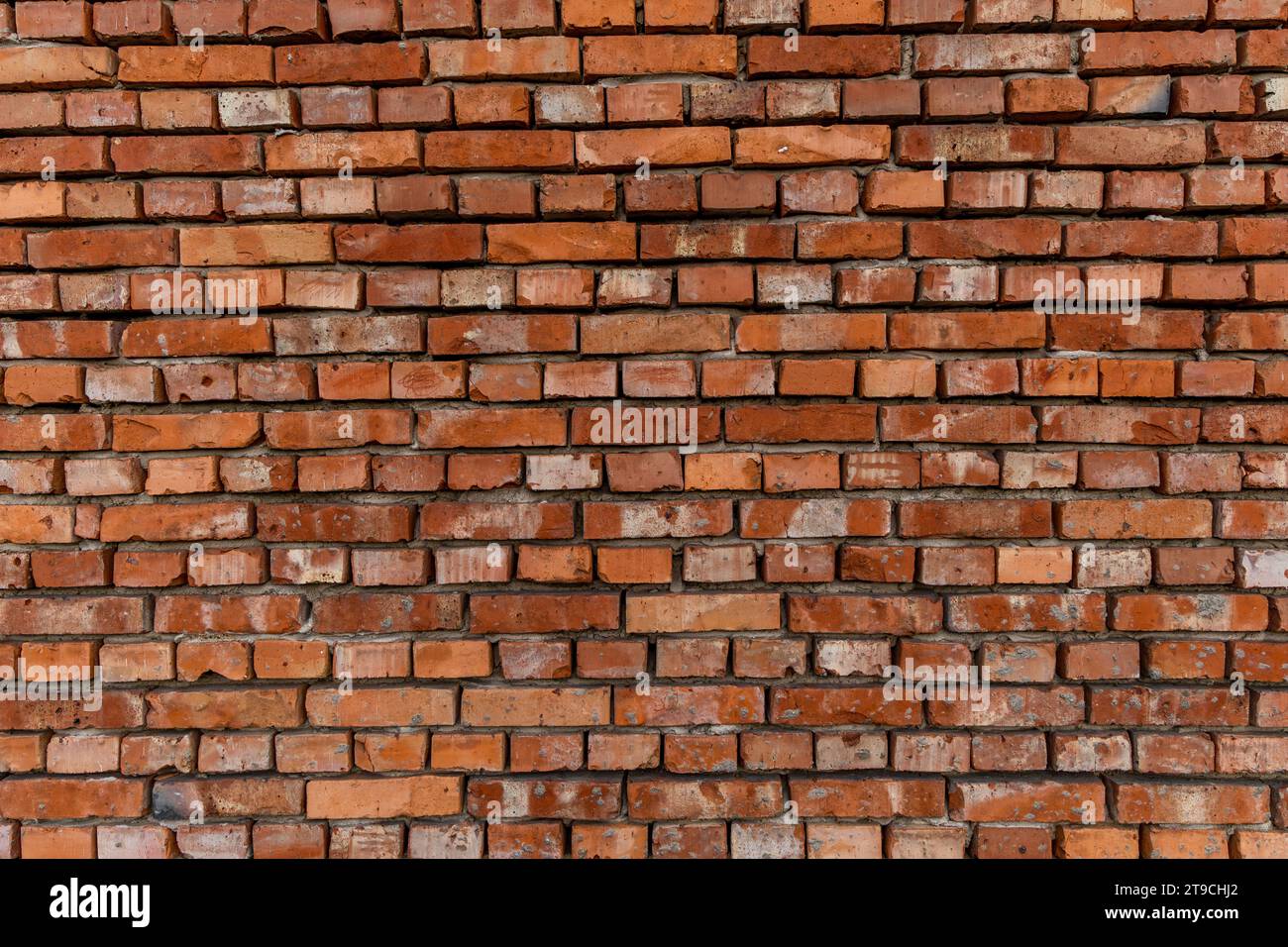 Red brick building scheduled for demolition, wrongly placed wall by the