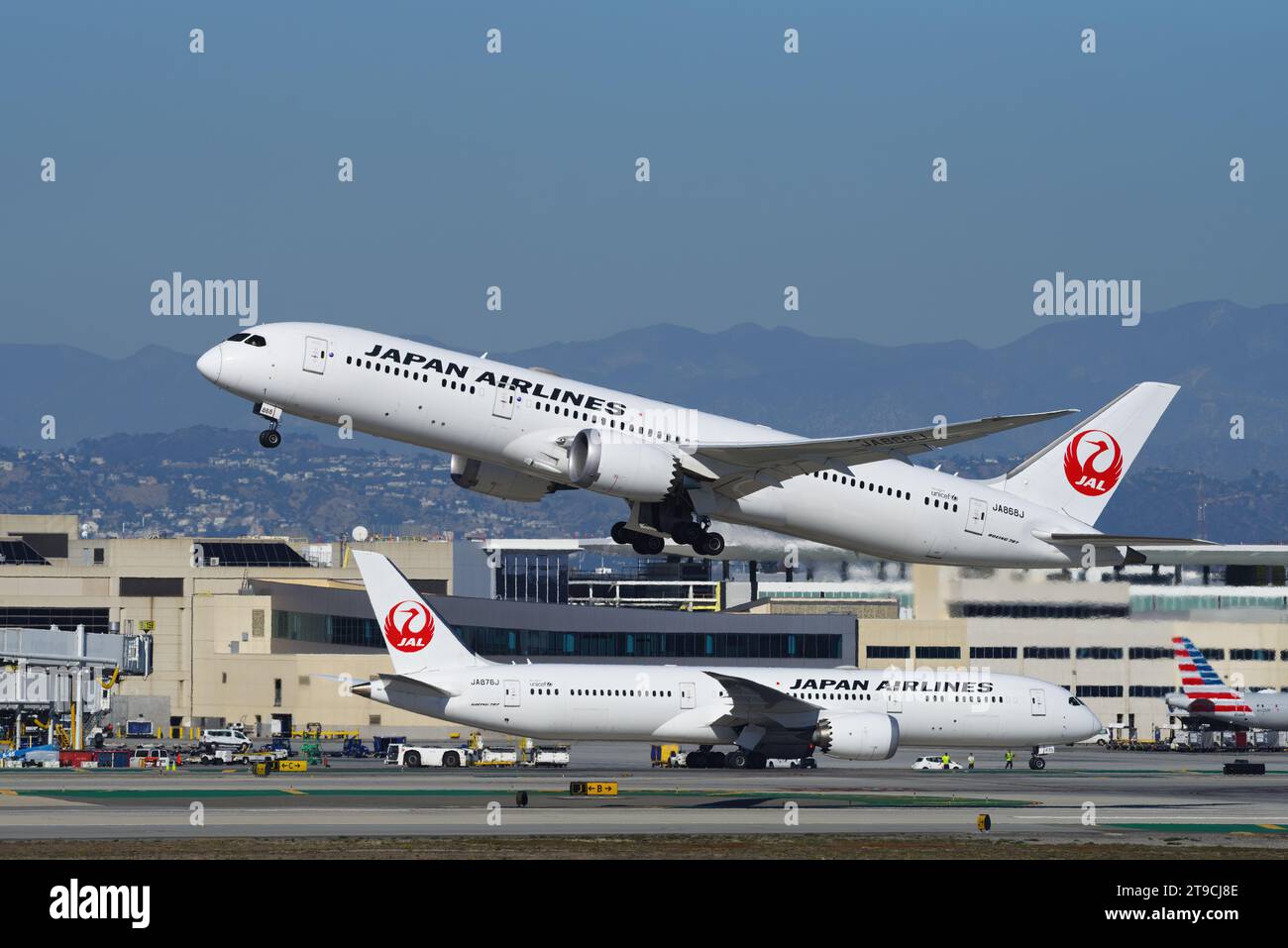 Two Japan Airlines, JAL, Boeing 787 airplanes shown taxiing and airborne, respectively. Shown at LAX, Los Angeles International Airport. Stock Photo