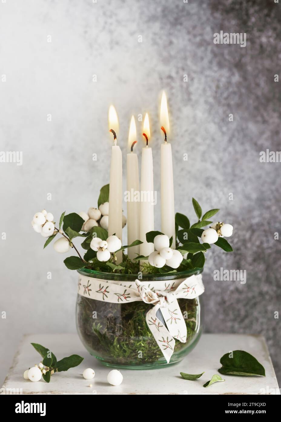 4. Advent. Christmas decoration with white advent candles and snowberry branches in glass jar. Handmade home decoration. (Symphoricarpos albus laeviga Stock Photo