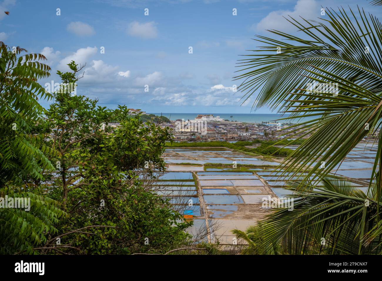 View on Elmina Castle in Ghana with trees and ocean Stock Photo