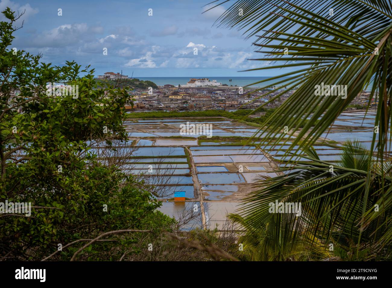 View on Elmina Castle in Ghana with trees and ocean Stock Photo