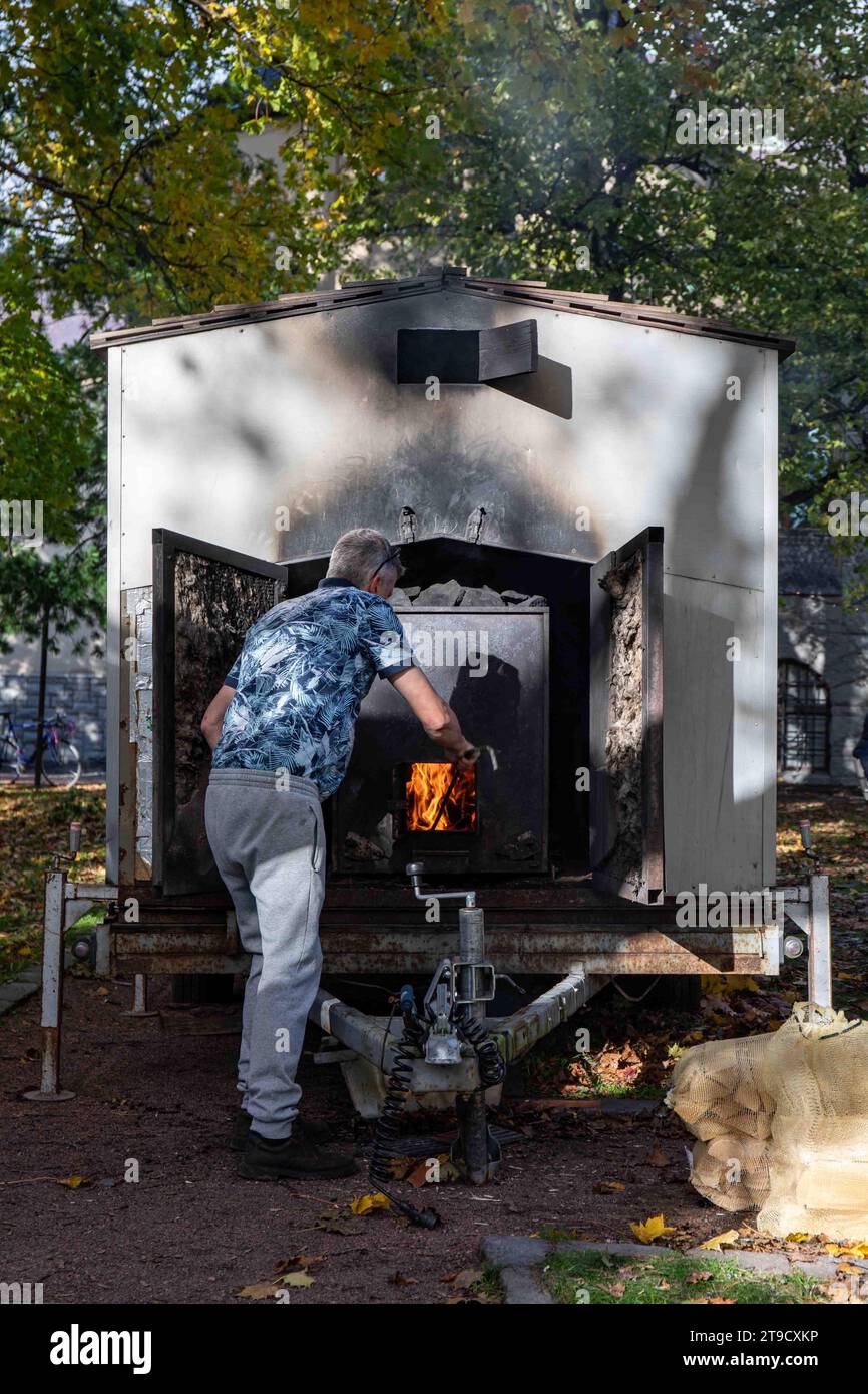 Man handling mobile smoke sauna fire in Helsinki, Finland Stock Photo