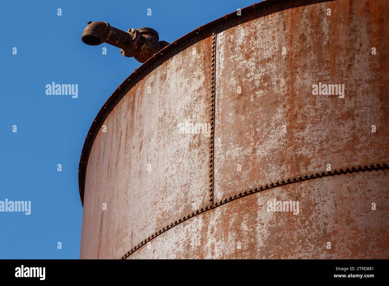 Close up of an old rusty water tower on blue sky background Stock Photo ...