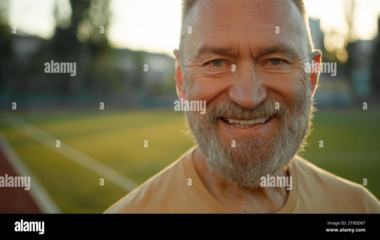Close up portrait Caucasian cheerful man smiling laughing looking at camera morning city outdoors fun sport sportsman enjoyment lifestyle happy old Stock Photo