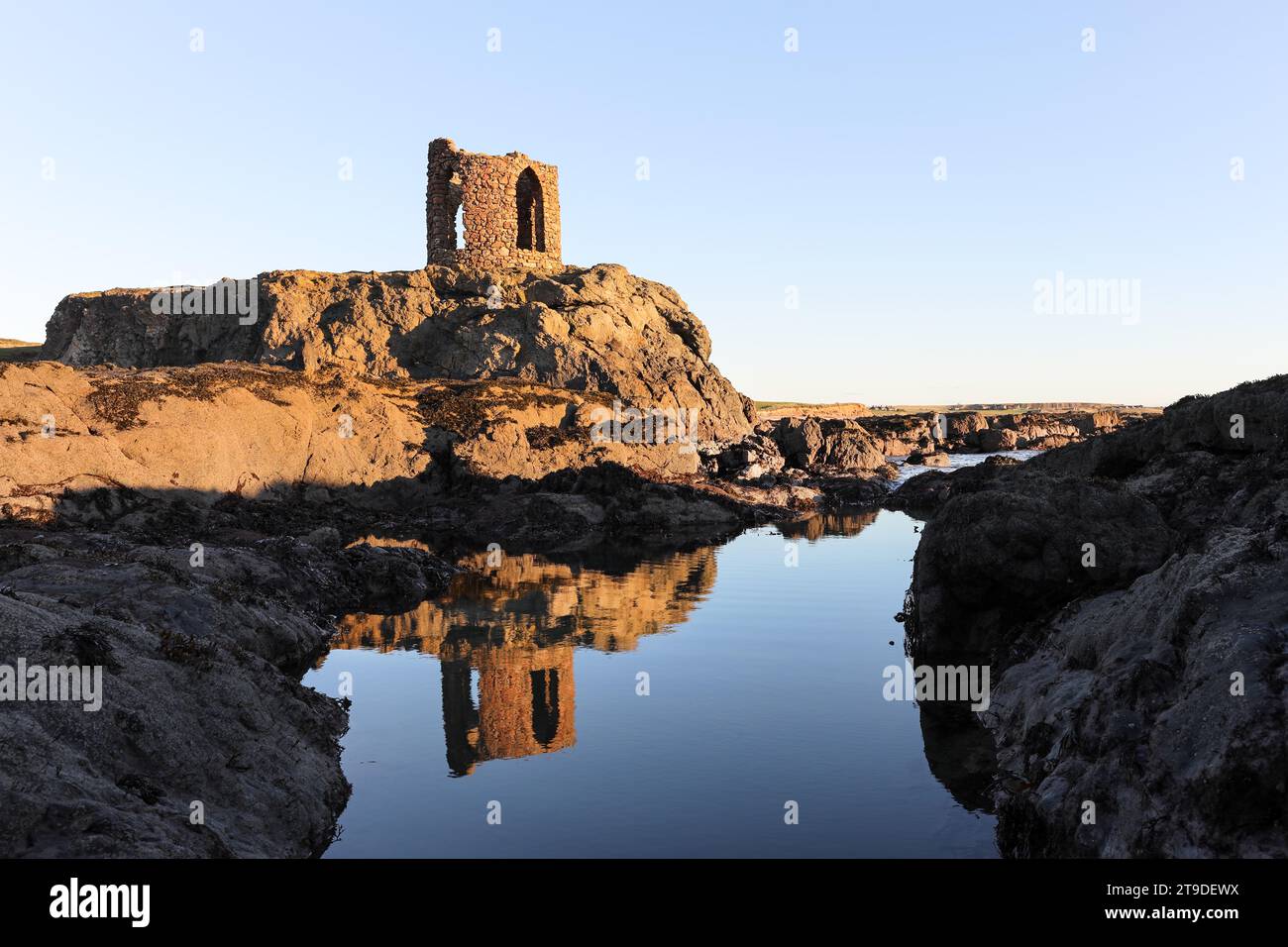 Lady’s Tower reflected in a rock pool in early morning light, Ruby Bay, Elie, Fife, Scotland, UK Stock Photo