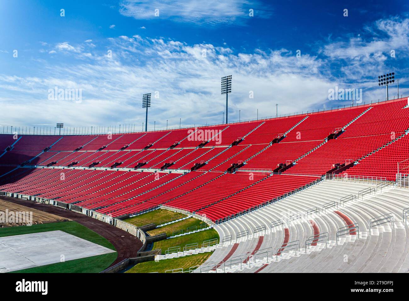 An athletic sports stadium on a sunny day with red seats Stock Photo