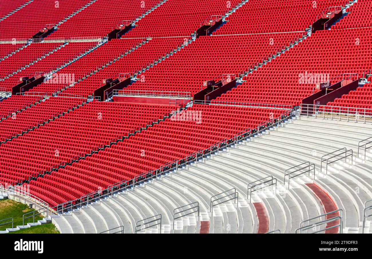 An athletic sports stadium on a sunny day with red seats Stock Photo