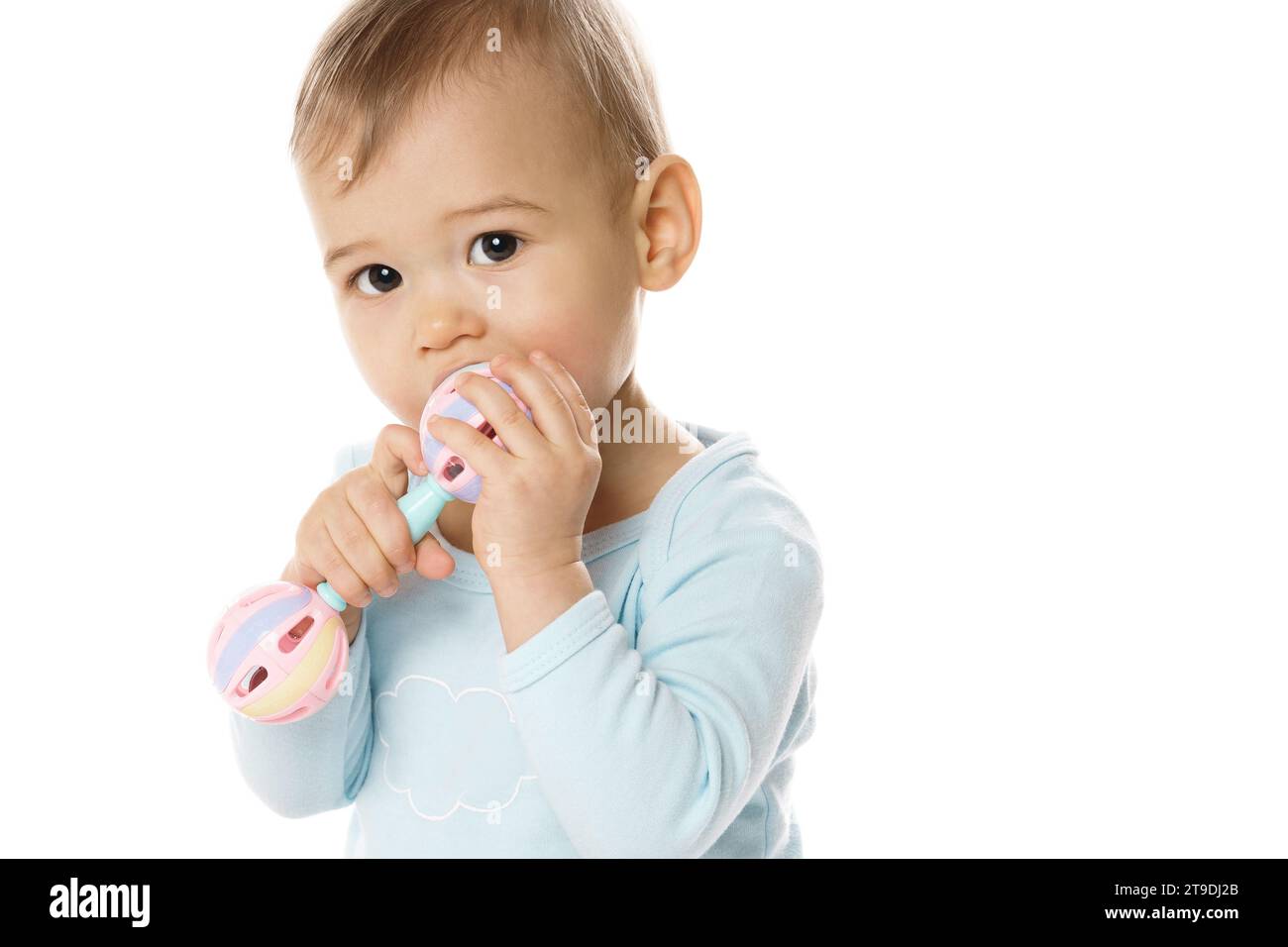 Adorable little boy in a romper is playing with plastic rattle and ...