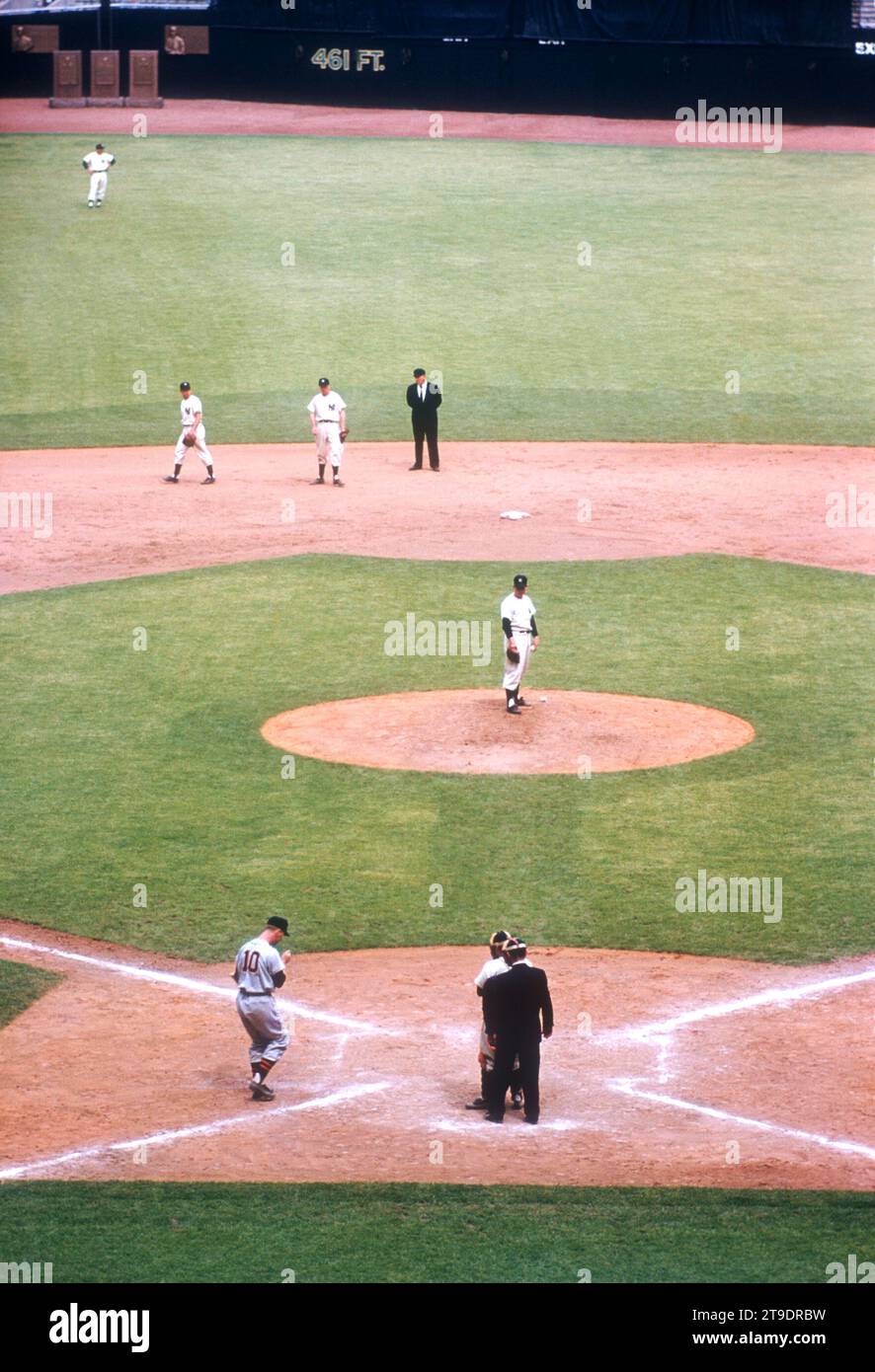 BRONX, NY - MAY 14:  Pitcher Whitey Ford #16 of the New York Yankees waits on the mound as Red Wilson #10 of the Detroit Tigers steps to the plate during an MLB game on May 14, 1955 at Yankee Stadium in the Bronx, New York.  (Photo by Hy Peskin) *** Local Caption *** Whitey Ford;Red Wilson Stock Photo