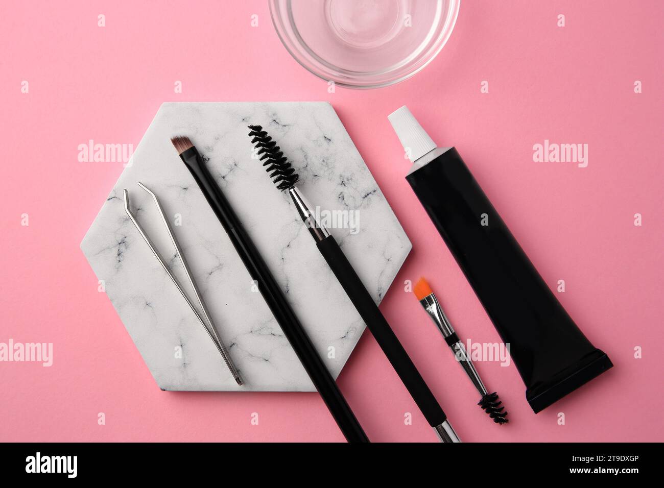 Flat lay composition with eyebrow henna and tools on pink background Stock Photo