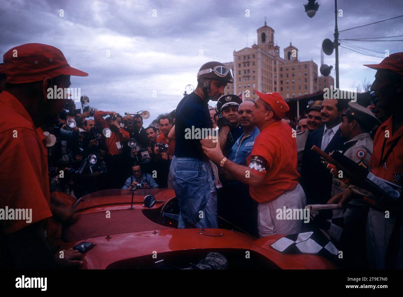 HAVANA, CUBA - FEBRUARY 24:  Juan Manuel Fangio (1911-1995) driver of the Maserati 300S climbs out of his car after the 1957 Cuban Grand Prix on February 24, 1957 in Havana, Cuba.  Fangio would win the race.  (Photo by Hy Peskin) *** Local Caption *** Juan Manuel Fangio Stock Photo