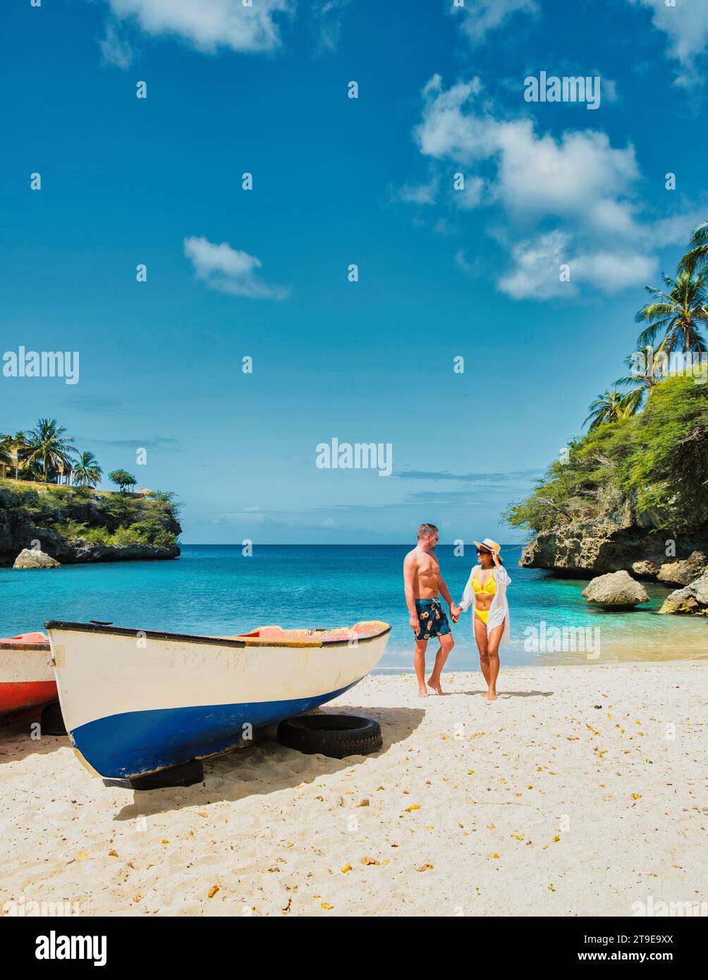 A couple of men and women in swimshorts and bikinis at Playa Lagun
