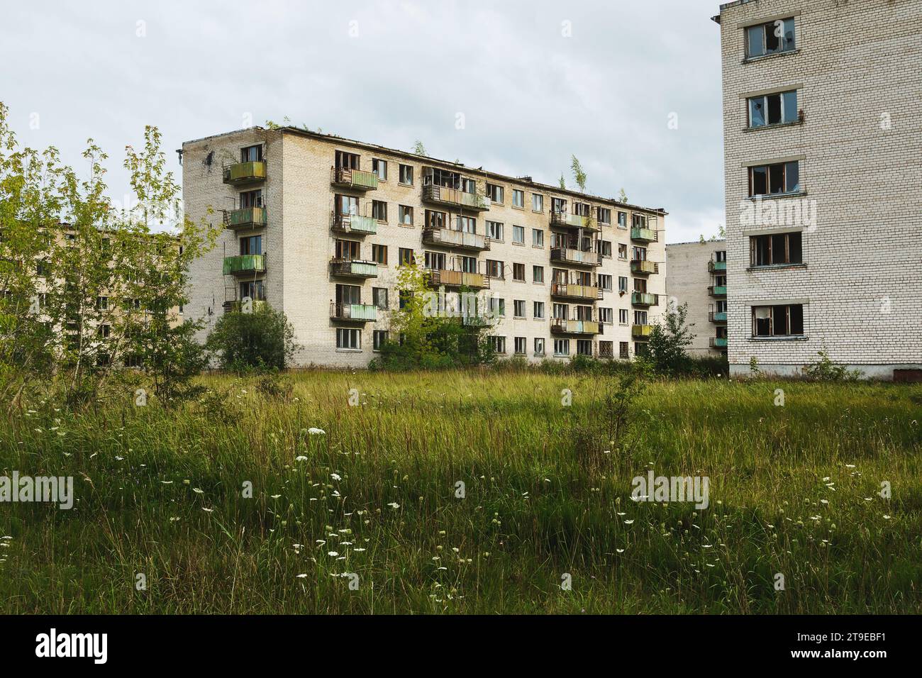 Exterior of an abandoned apartment buildings with broken windows in a ...
