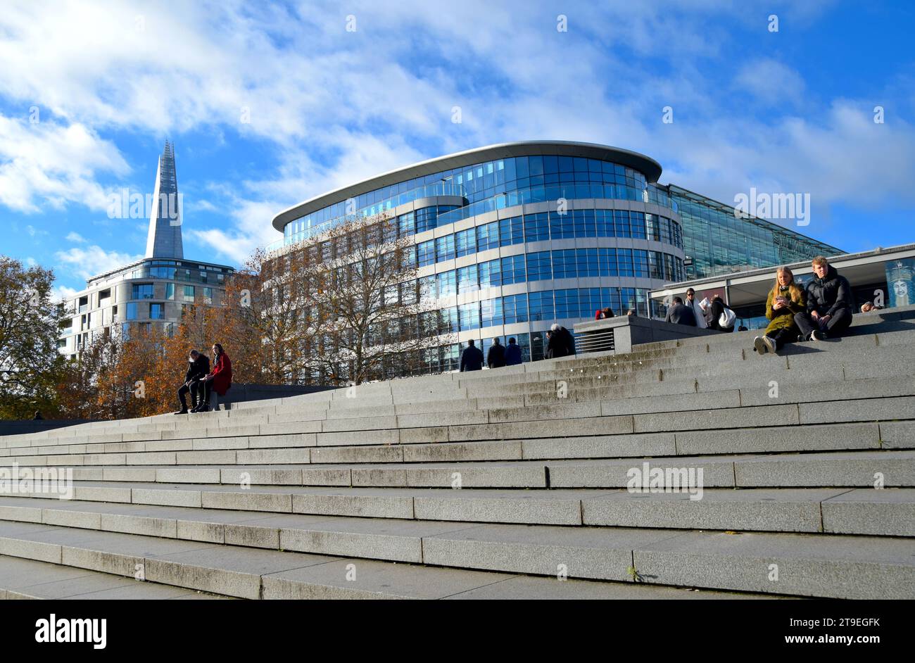 Winter colour on a week day in London. Image shows people enjoying the good weather on Tower Hill, London. Stock Photo
